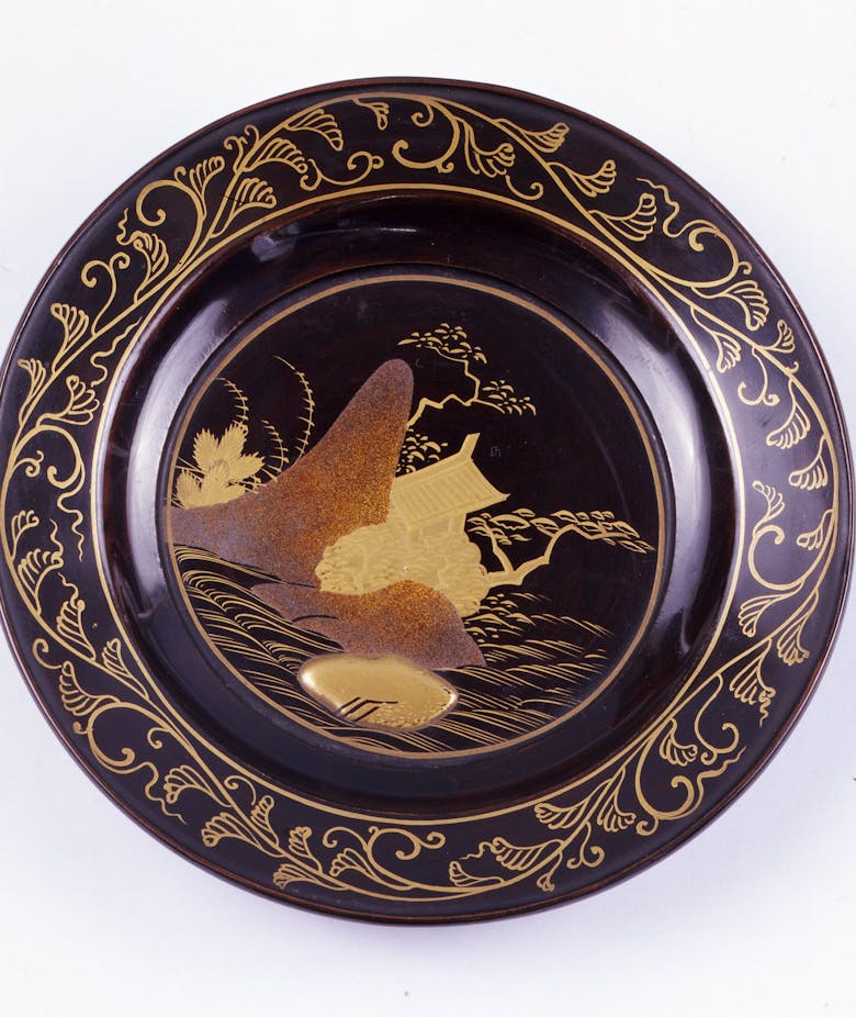 Japanese lacquered and painted plate featuring a river landscape with plants